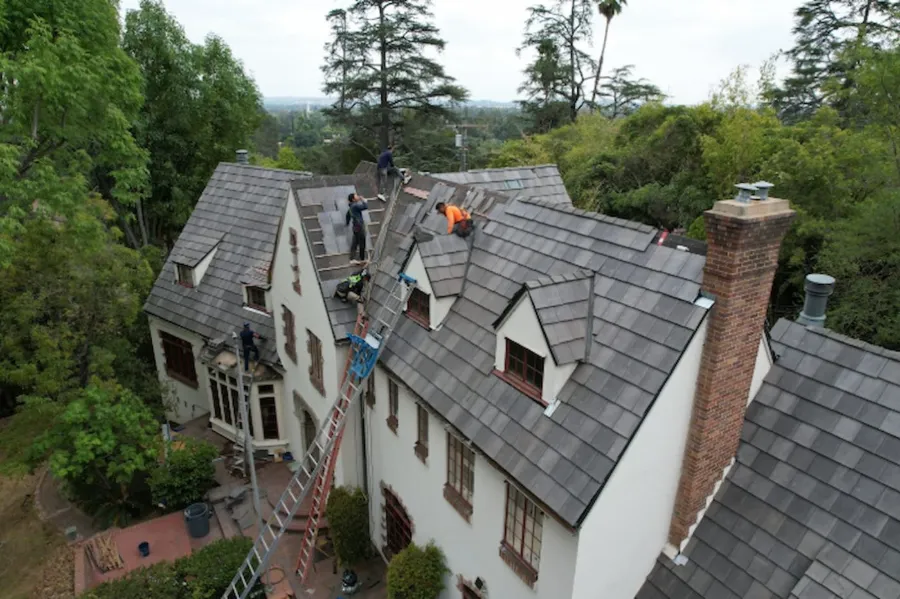 Crew installing tile on a Tudor roof